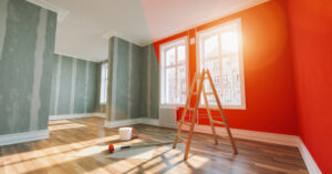 Painting wall red in room before and after restoration or refurbishment